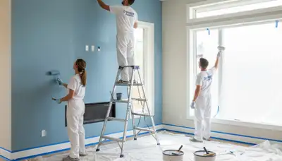Professional interior house painters working in Tulsa, OK home with premium wall paint finish